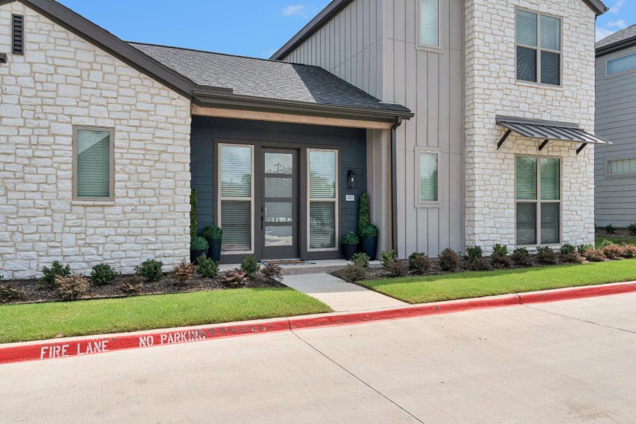 the front of a home with a driveway and grass at The parcHAUS at Firewheel Parkway