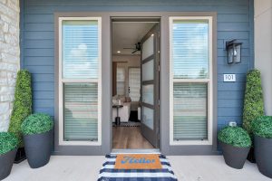 a front door with a potted plant and a rug at The parcHAUS at Firewheel Parkway