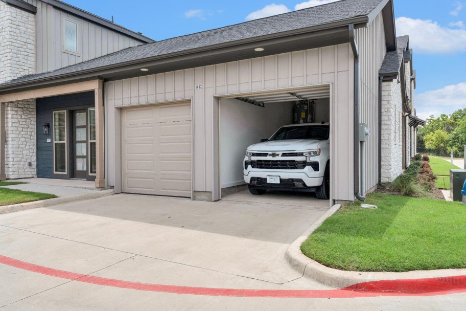 a white truck is parked in front of a garage at The parcHAUS at Firewheel Parkway