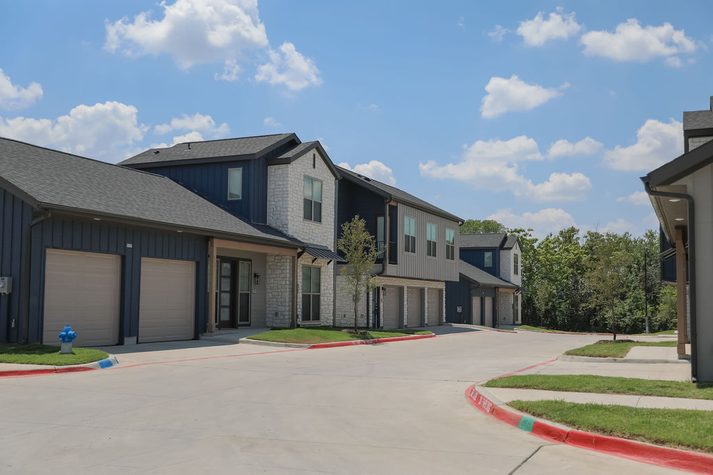 the exterior of a residential complex with garages at The parcHAUS at Firewheel Parkway